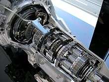 Cutaway car transmission, with exposed gears and internal machinery.