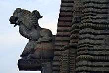 A sculpted griffin on the main temple spire