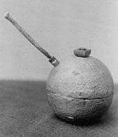 A unexploded dynamite bomb with fuse.
