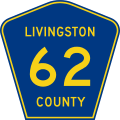 A blue pentagon with a yellow border and three lines of yellow text, reading Livingston County 62.