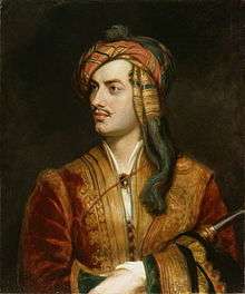 Half-length portrait of pale man in his mid twenties, sitting in red coat with gold trim. His left hand is holding an obscured tubular object that is pressed against his body. His dark brown hair is wrapped in an orange and red bandana, and he has a thin moustache.