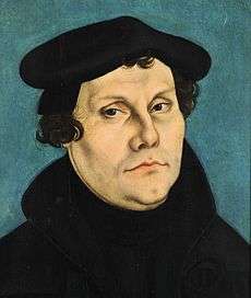 Portrait of Luther by the painter Lucas Cranach the Elder, showing the face in detail, while hair, jacket and a barett are black and frame it