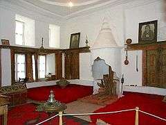 Two large beds near the floor, with a fireplace between them