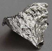 A rough fragment of lustrous silvery metal