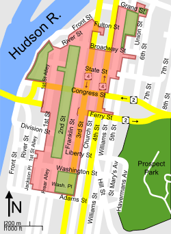A map of the district shows its irregular shape, which extends roughly from Adams Street at the south to Grand Street at the north; and First Street, River Street, Front Street at the west to Third Street, Fourth Street, and Union Street at the east.