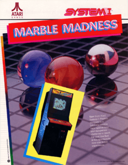 Artwork of a vertical rectangular advertisement flyer. Pictured is an image of an arcade cabinet in front of an image of red, blue, and silver marbles on a gridded plane. The top left corner displays the Atari logo, while the top right corner reads "System I". Below the logo readers "Marble Madness".