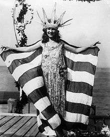 Woman with crown, holding a large flag