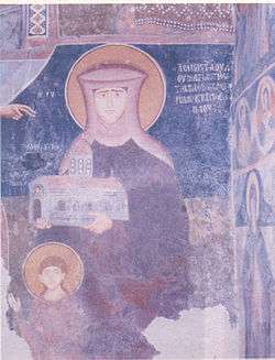 Medieval mural portrait on the interior walls of a church depicting an Orthodox nun holding a model of the church