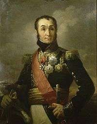Painting shows a clean-shaven man with a cleft chin, receding hairline and high-arching eyebrows. He wears a dark blue military uniform with much gold braid, many medals and a red sash.