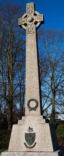  Monumental cross of granite in an outdoor setting with bare trees