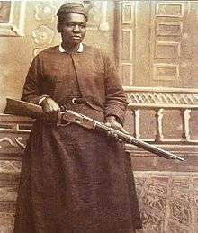 Sepia-tone photograph of Mary Fields, holding a rifle