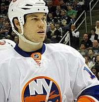 Matt Martin wearing an Islanders helmet staring out across the ice.