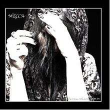 Black and white photo of Persia White, with her hands and hair mostly covering her face