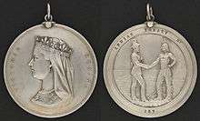 Two sides of a silver medal: the profile of Queen Victoria and the inscription "Victoria Regina" on one side, a man in European garb shaking hands with an Aboriginal with the inscription Indian Treaty No. 187 on the other