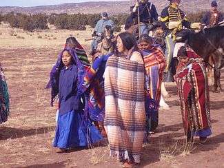 Navajo Indians in period dress for late 1860s, being escorted by white soldiers