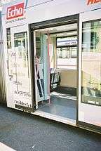 Entry door of a low-floor tram, with "roll-in" level floor accessibility.