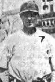 A blurry black-and-white image of a man in a white baseball uniform with a 7 over the left breast