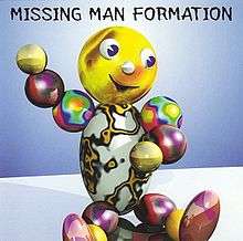 A smiling anthropomorphic figure, made of shiny, colorful spherical and egg-shaped objects