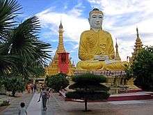 color monument of Buddha in lotus position, Shwezigon Paya near Bagan, Myanmar