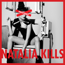 Kills is seen sat on an exam chair, with a red X covering her eyes. The X contains the text "Perfectionist" while the bottom of the image has "Natalia Kills" written on it.
