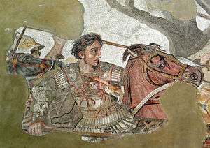A young, clean-shaven man in heavy armour sits astride a brown horse. His breastplate bears the face of the Medusa. Although his companions wear metal helms, only his short curly dark hair separates him from a deadly blow. In his right hand he grasps the shaft of a long spear. His determined face stares in sharp profile toward the right of the picture.