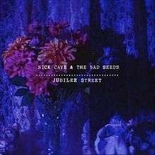 An image of purple flowers against various shades of blue. White text reads "Nick Cave & the Bad Seeds Jubilee Street"