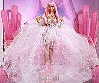 A plastic doll on display wearing a gauzy, pale gown with a neon pink wig and matching stilettos.