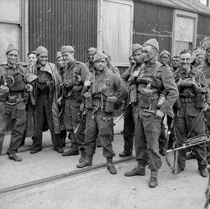 A group of 15 men in uniform carrying weapons