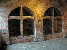 Two brick-built arched wine bins, each divided into four sections, the lower ones being larger than the upper