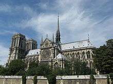 Notre Dame, Paris, is a grand Gothic cathedral with Towers at one end and a small spire rising from the centre of the roof.