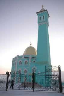Teal mosque with small gold dome
