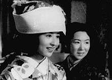 A photo of Kyoko Kagawa in a fancy traditional dress, next to another woman.