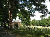 The small church and cemetery, behind the iron fence