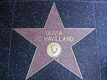 Five-pointed star with her name and an image of an old film camera