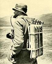 Photo of four gas cylinders strapped on someone's back