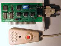 An internally mounted PC card with a serial port connected to a small controller.
