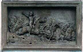 Plaque showing General Pajol leading a cavalry charge at the Battle of Montereau.