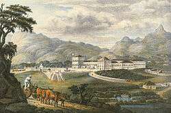 A colored lithograph depicting a large, white palace complex with a carriage entering a paved forecourt and forested mountains rising in the background.
