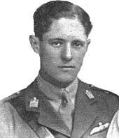 A portrait photograph of a young white man with dark hair, wearing a British military uniform