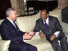 Colin Powell and Cameroon president Paul Biya, smiling and talking