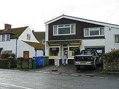 modern building with shop. Sign over window says Pawlett Country Store & Off Licence.