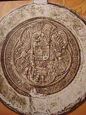 A seal depicting three coat of arms held by two armored men