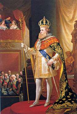 Full length painted portrait of a bearded man wearing a gold crown, mantle and sword and grasping a long scepter