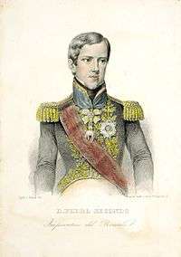An engraving depicting a young, clean-shaven man with wavy hair and wearing a military-style embroidered tunic with epaulets, a sash across the chest, and medals on the breast and on a ribbon around his neck