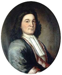 A head and shoulders portrait of Phips. He has dark hair, and wears a magistrate's robe.