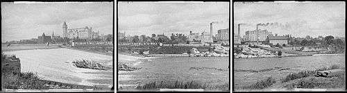 panorama seen from west side of river looking east, large sign or banner says "Pillsbury A Mill, Largest Flour Mill in the World"