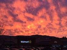 Sunset over Plymouth Walmart location. Windmills atop Tenney Mountain visible in the background.