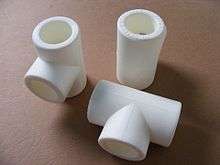 Three white plastic fittings: two tees and a union