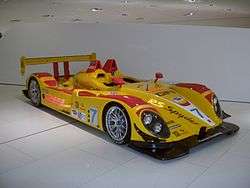 Picture of bright yellow and red RS Spyder racing car in a museum