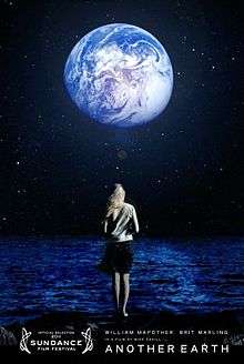 A woman standing by the water, in the night sky Earth can be seen.